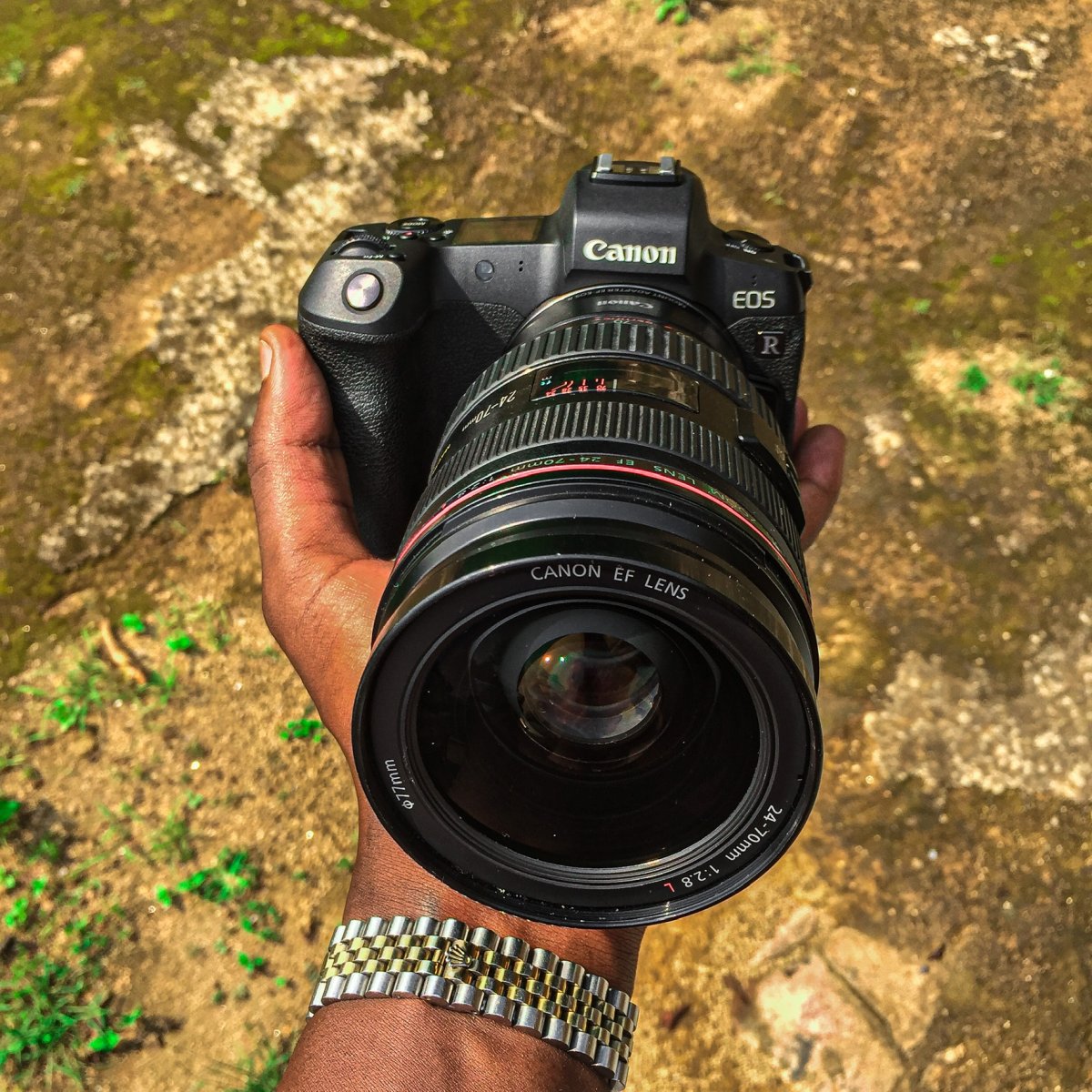 Holding a canon EOS R Camera