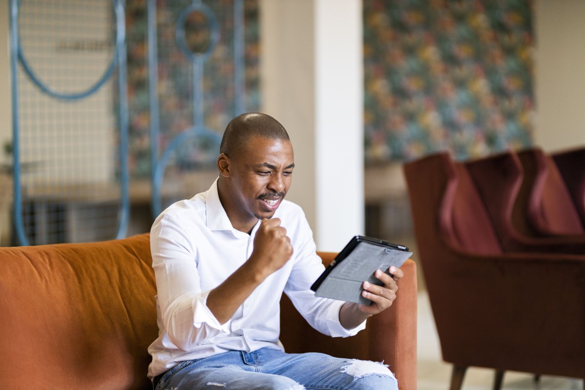 Black business man celebrating a win with a fist pump