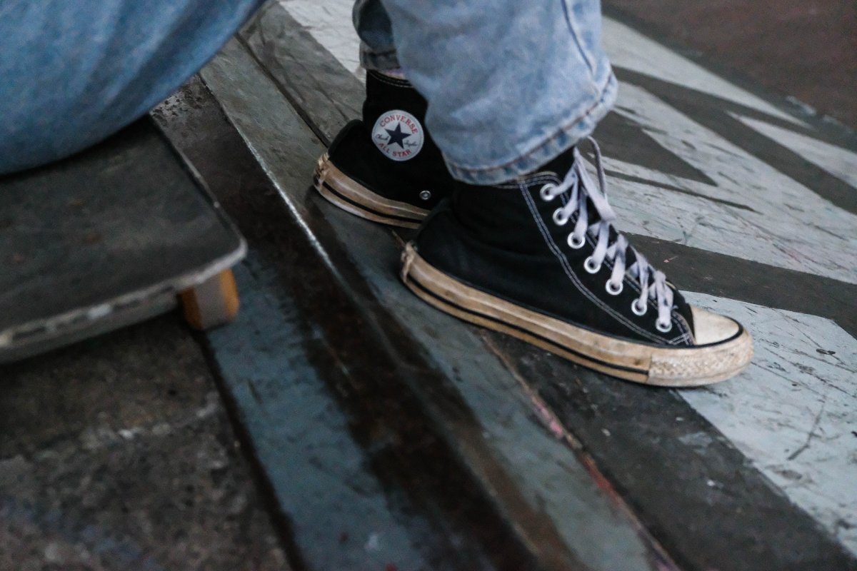 Skateboarder girl wearing converse shoes at the park in Cape Town