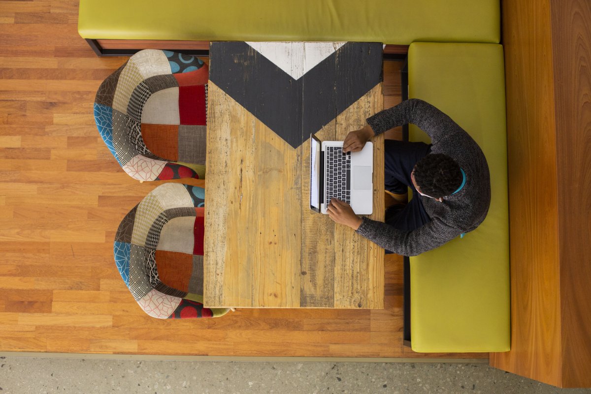 Black man sitting in the office cafeteria working