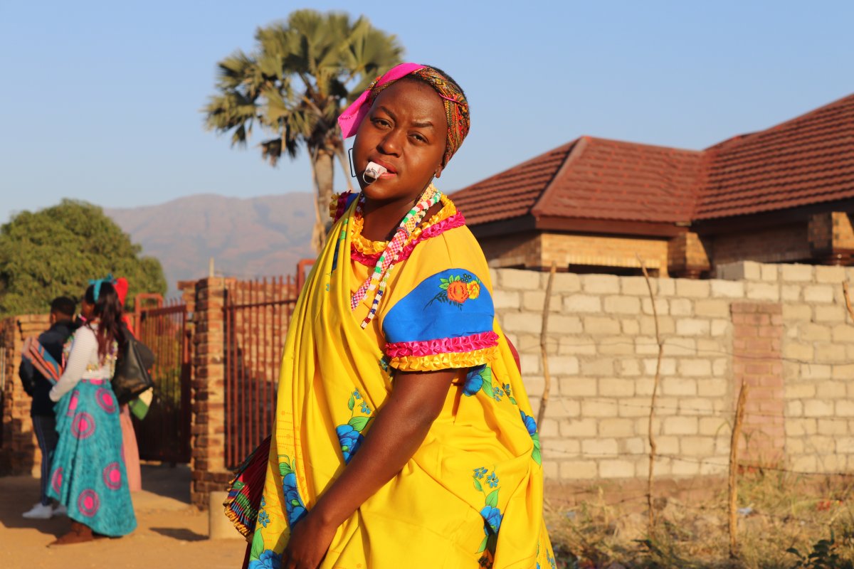 Tsonga woman dancing with a whistle in traditional attire