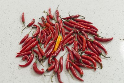 Yellow chilli in the middle of red chillis