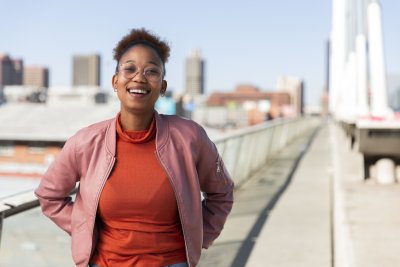 Black woman on Nelson Mandela bridge smiling at camera