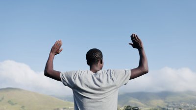 Black man praying in the mountains
