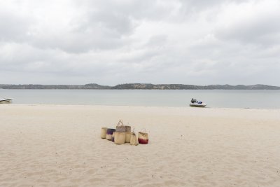 Group of baskets on sand near a lagoon