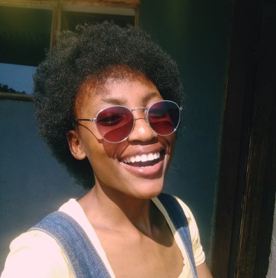 Black woman with afro laughing.