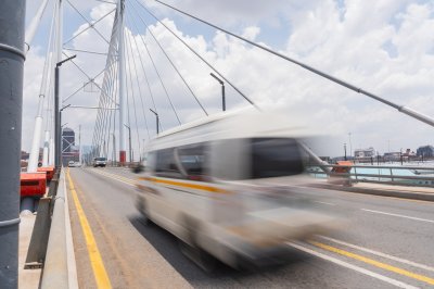 Taxi passing Nelson Mandela bridge fast