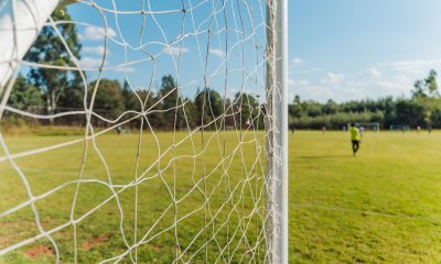 Soccer goal post with goalkeeper in the background