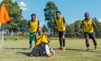 Soccer players celebrating a goal on the sideline