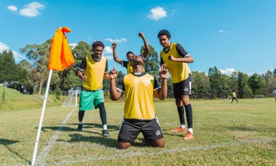 Soccer players celebrating a goal wearing yellow