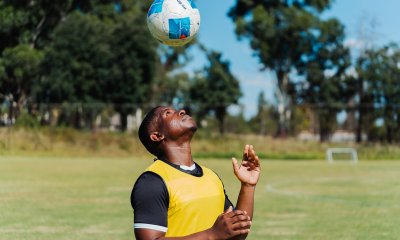 Soccer player playing with ball on his head