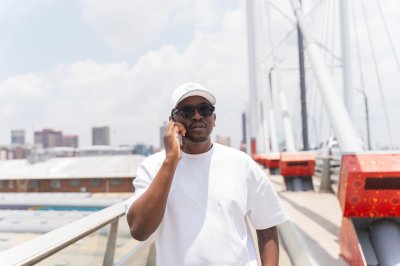 Black African man talking and walking on the phone
