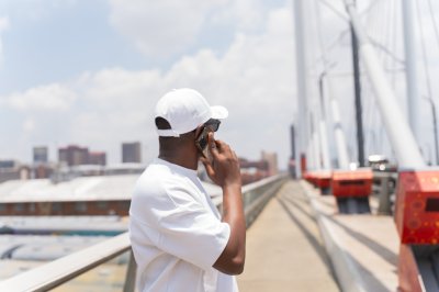 Black man talking on the phone looking away from camera
