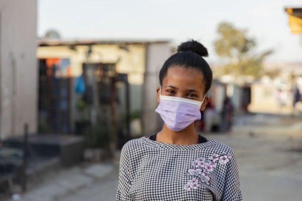 Young black woman wearing mask ekasi