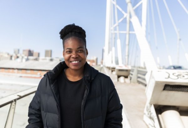Black woman wearing all black smiling