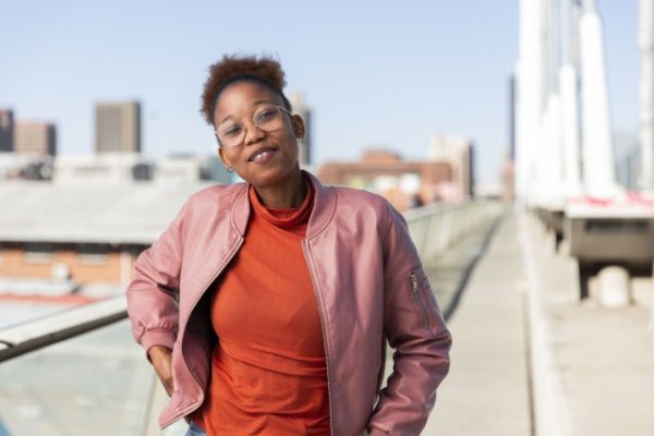 Black woman on Nelson Mandela bridge smiling