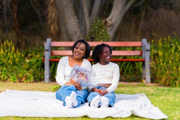 African mother and daughter enjoying a picnic at a park