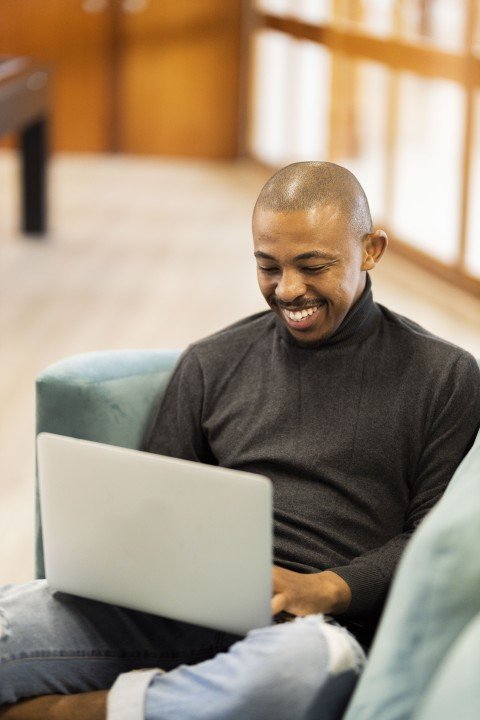 Black man working on his laptop at home