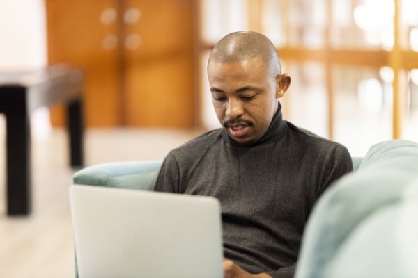 Black man working on his laptop at home