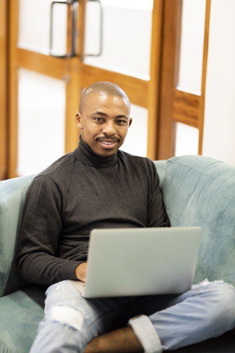 Black man working on his laptop at home