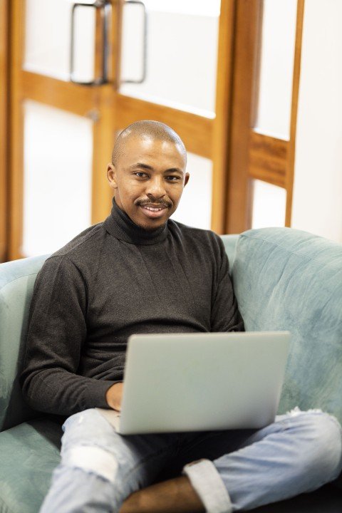 Black man working on his laptop at home