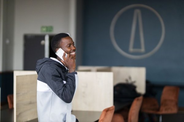 Black man talking on his cellphone and smiling