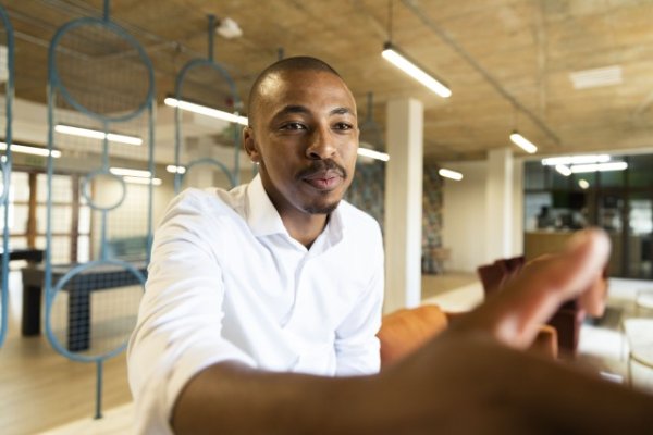 Black business man approaching to shake hands with a client
