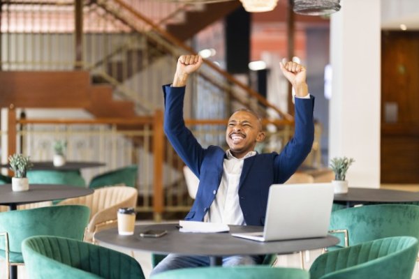 Black business man at work celebrating