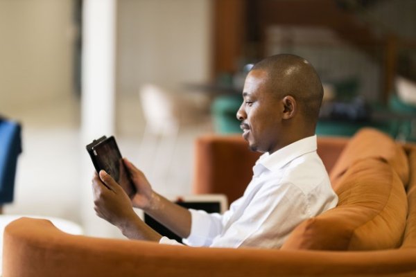Black business man looking at his tablet