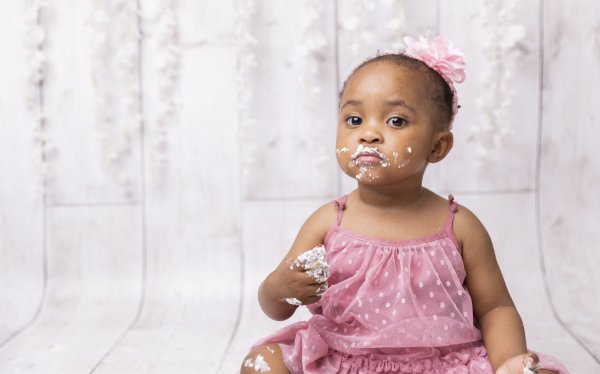 Black child playing with cake