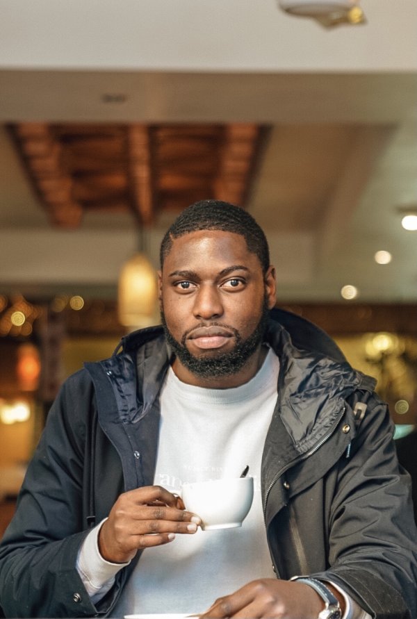 Black Man Having Tea/Coffee