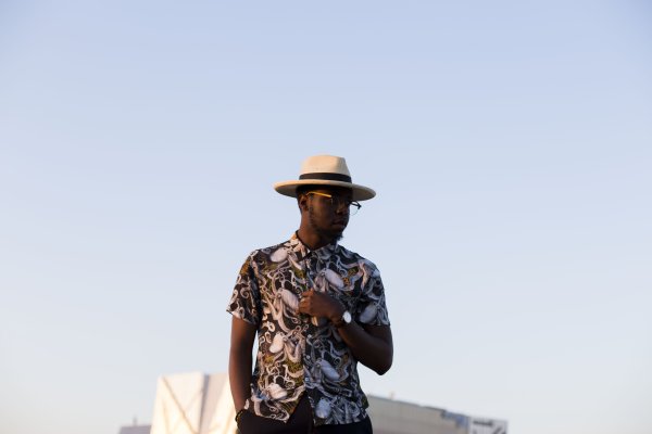 Black man posing with a skyline