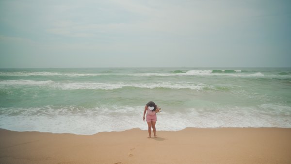 Black woman at Umhlanga beach enjoying the water