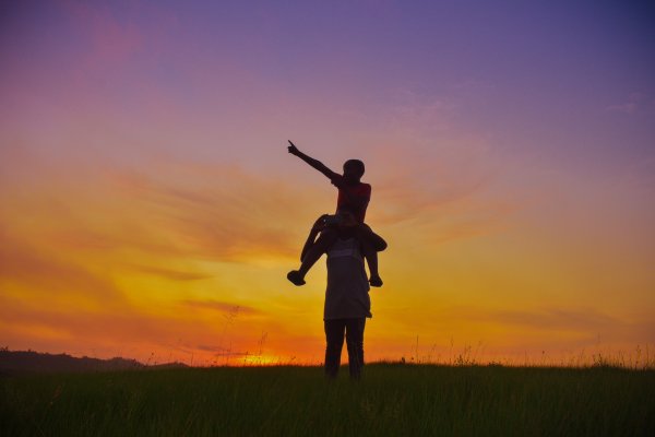 Brothers that look out for each other enjoy the last hour of sunset taking selfies in the mountains
