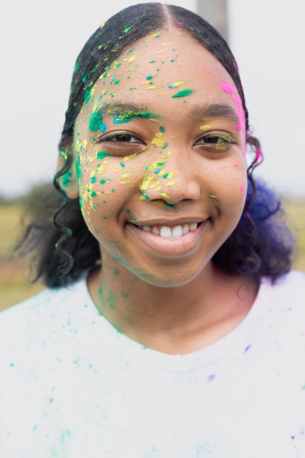 black woman having fun at Colour Fun Run