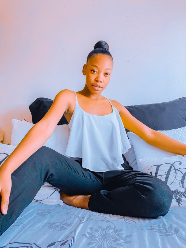 Black girl sitting on the bed