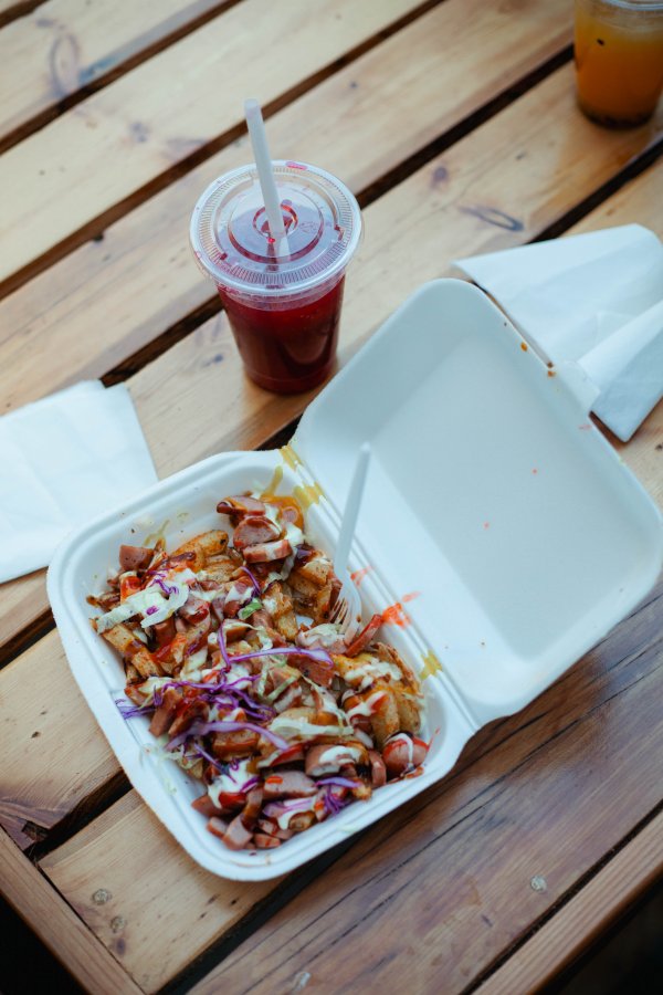 Chips and Russian lunch in a takeaway plate