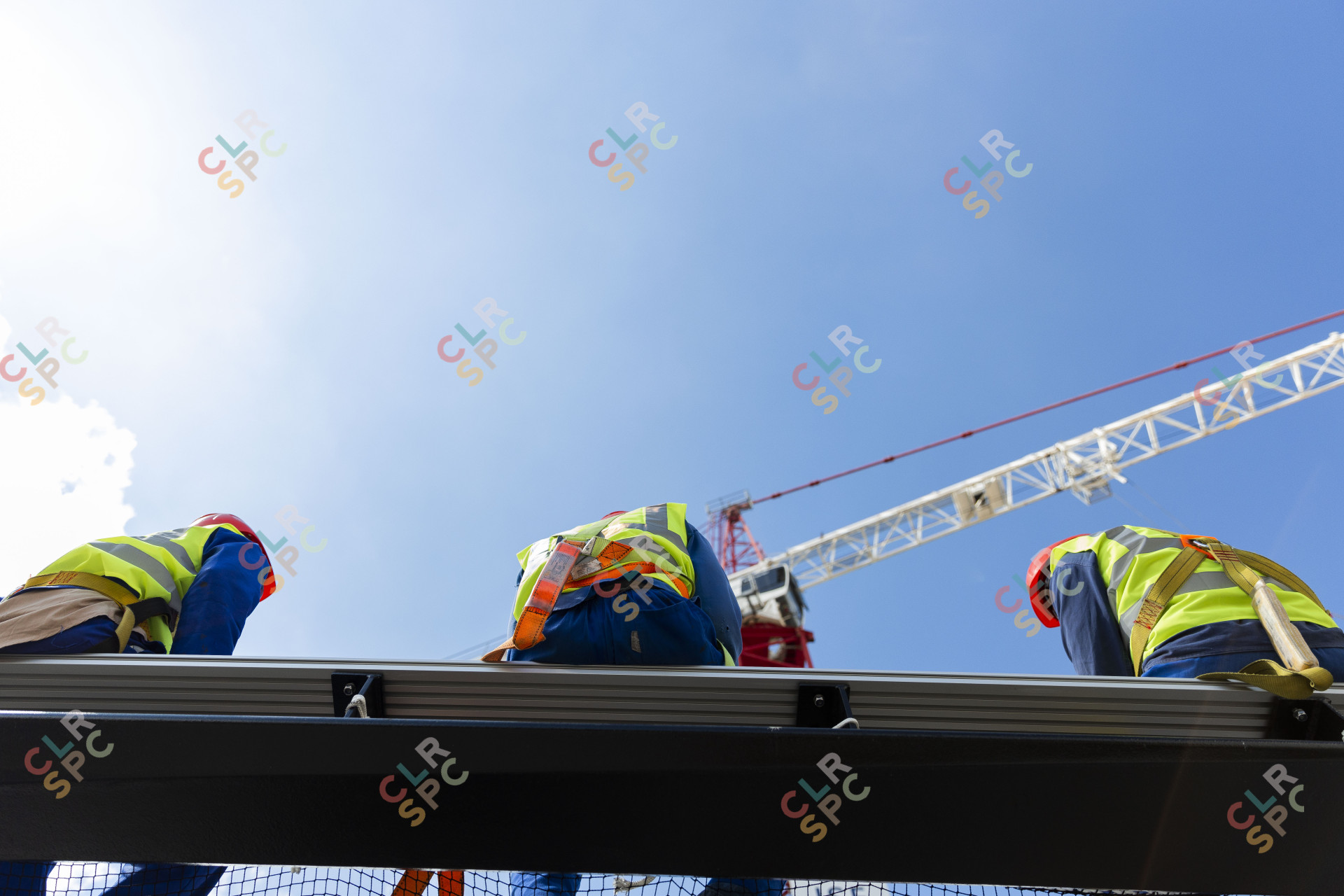 Black men in construction wearing safety belts
