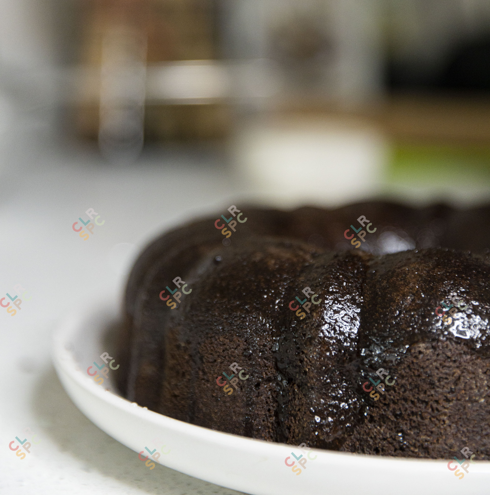 Coating a chocolate cake with a brush