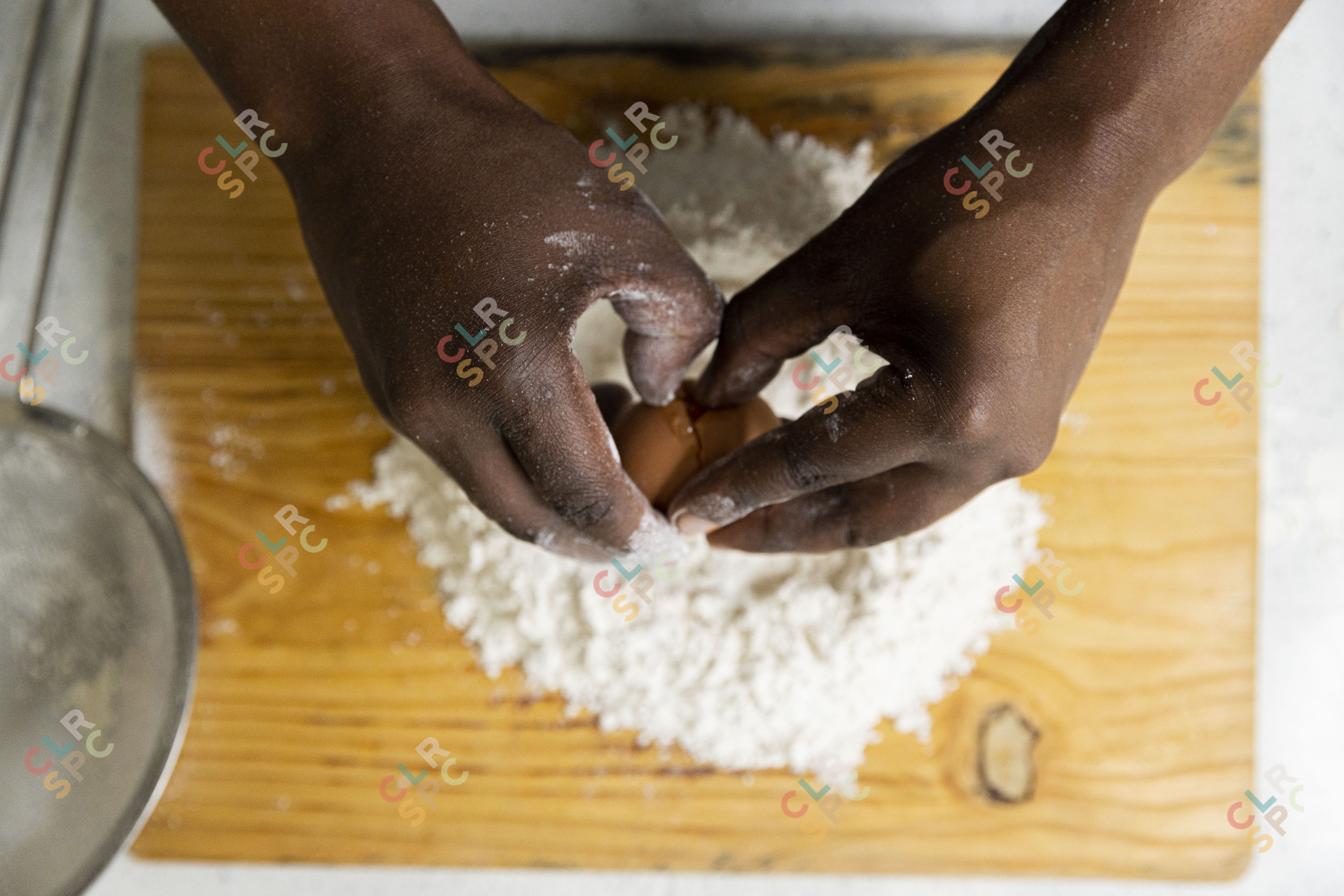Cracking  an egg inside flour for baking