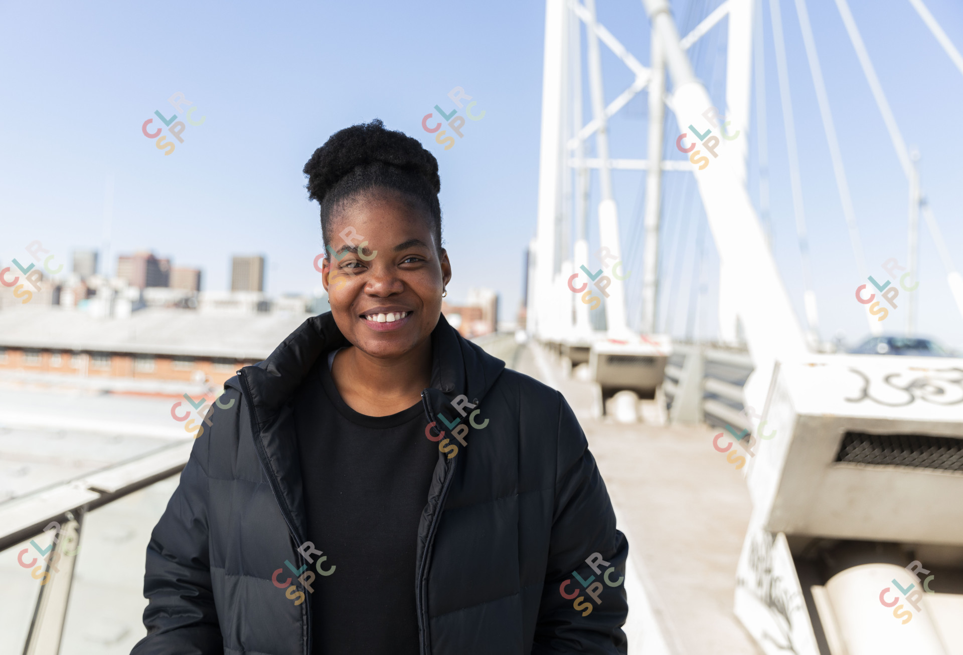 Black woman wearing all black smiling
