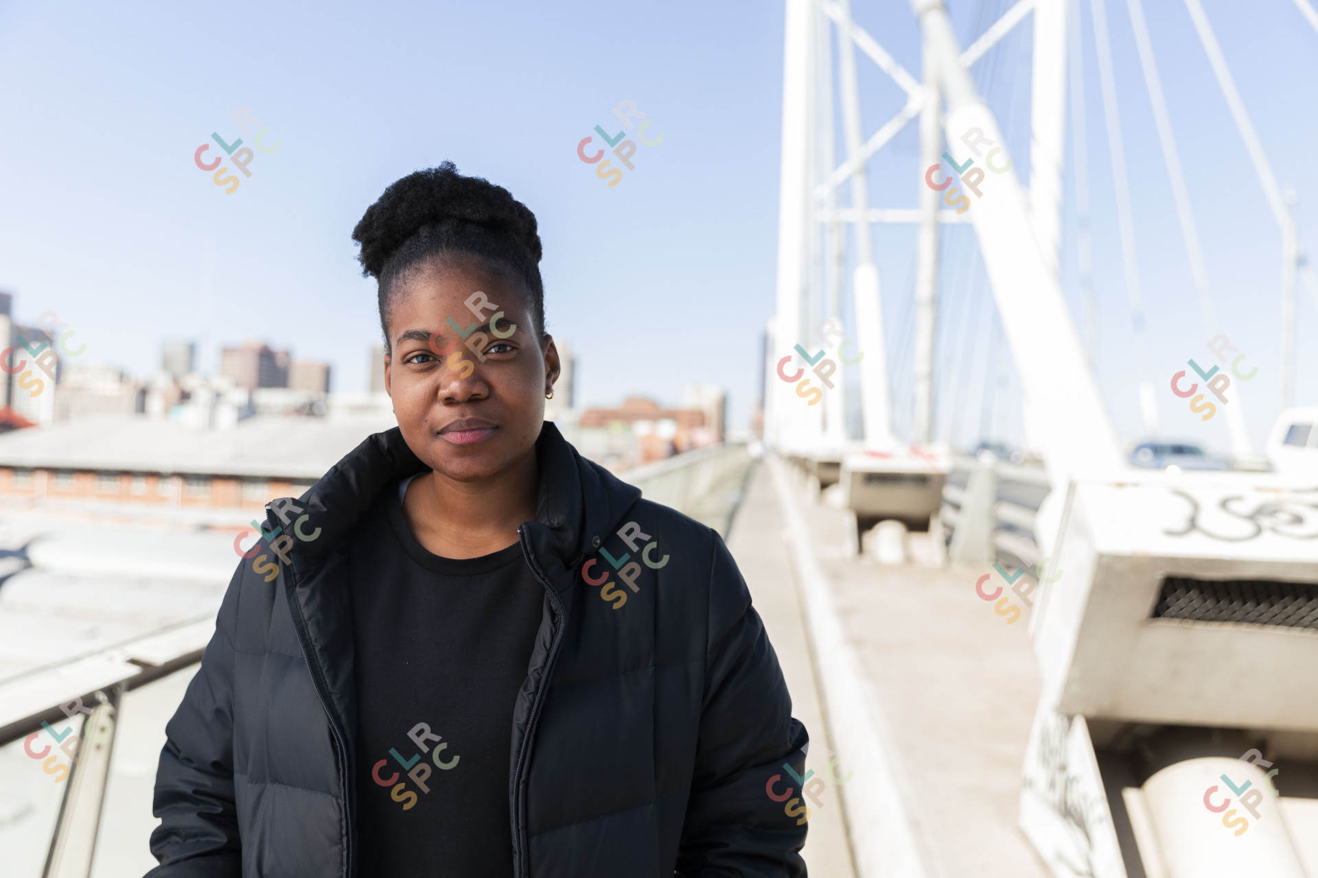Black woman wearing all black on a bridge in South Africa
