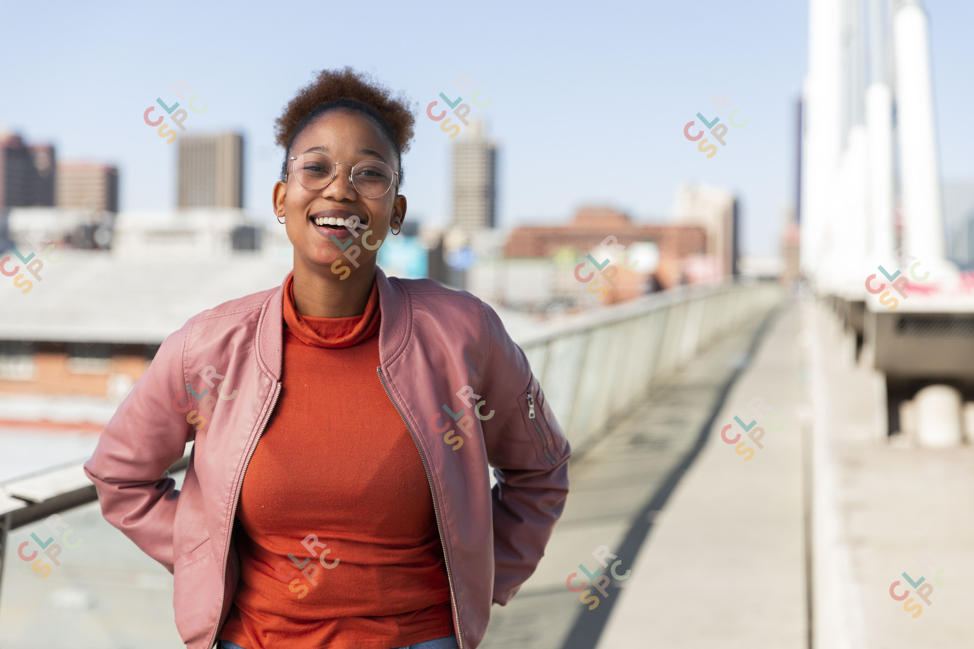 Black woman on Nelson Mandela bridge smiling at camera