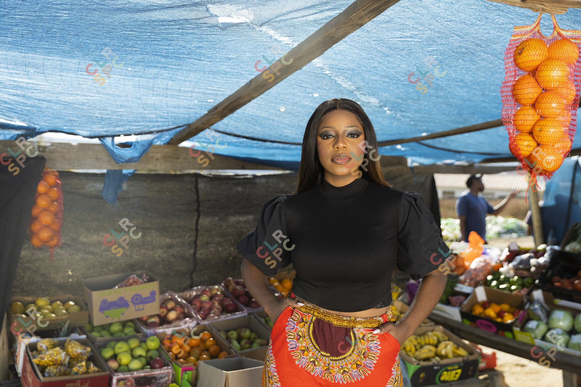 Black woman at the fruit market looking at the camera