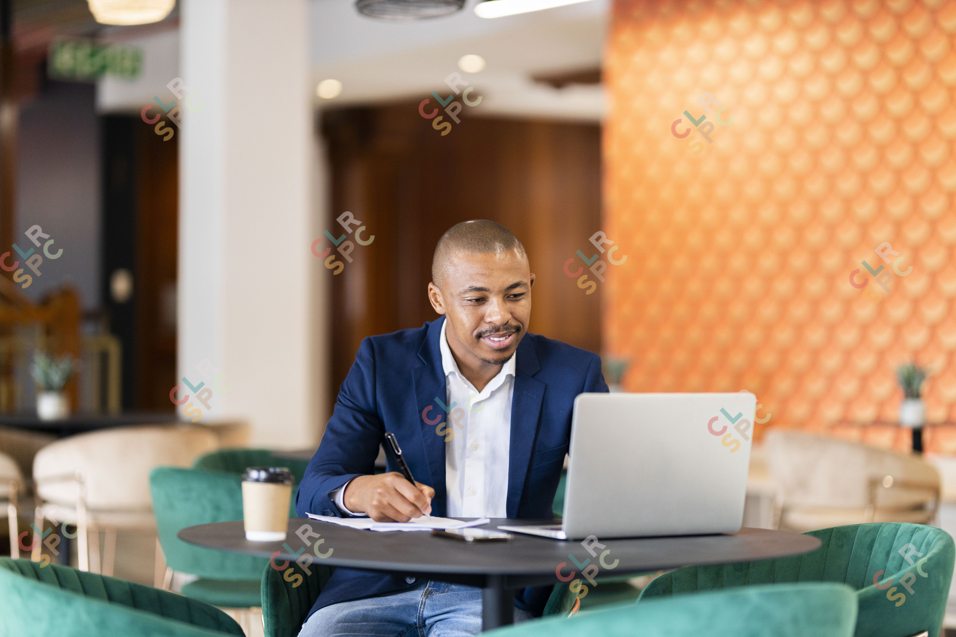 Black business man working on his laptop at the coffee shop