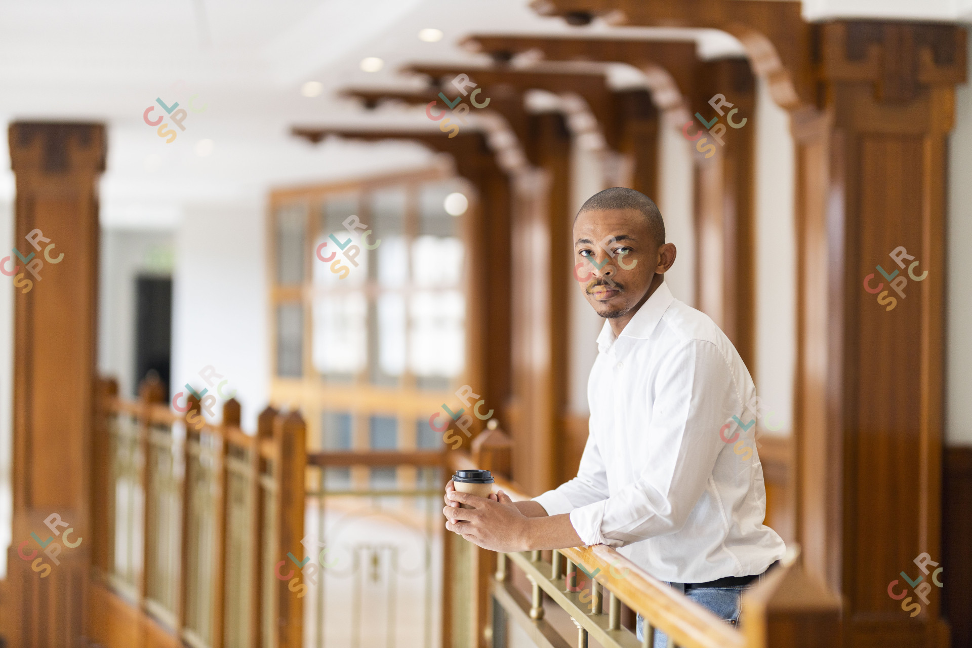 Black business man at work holding coffee