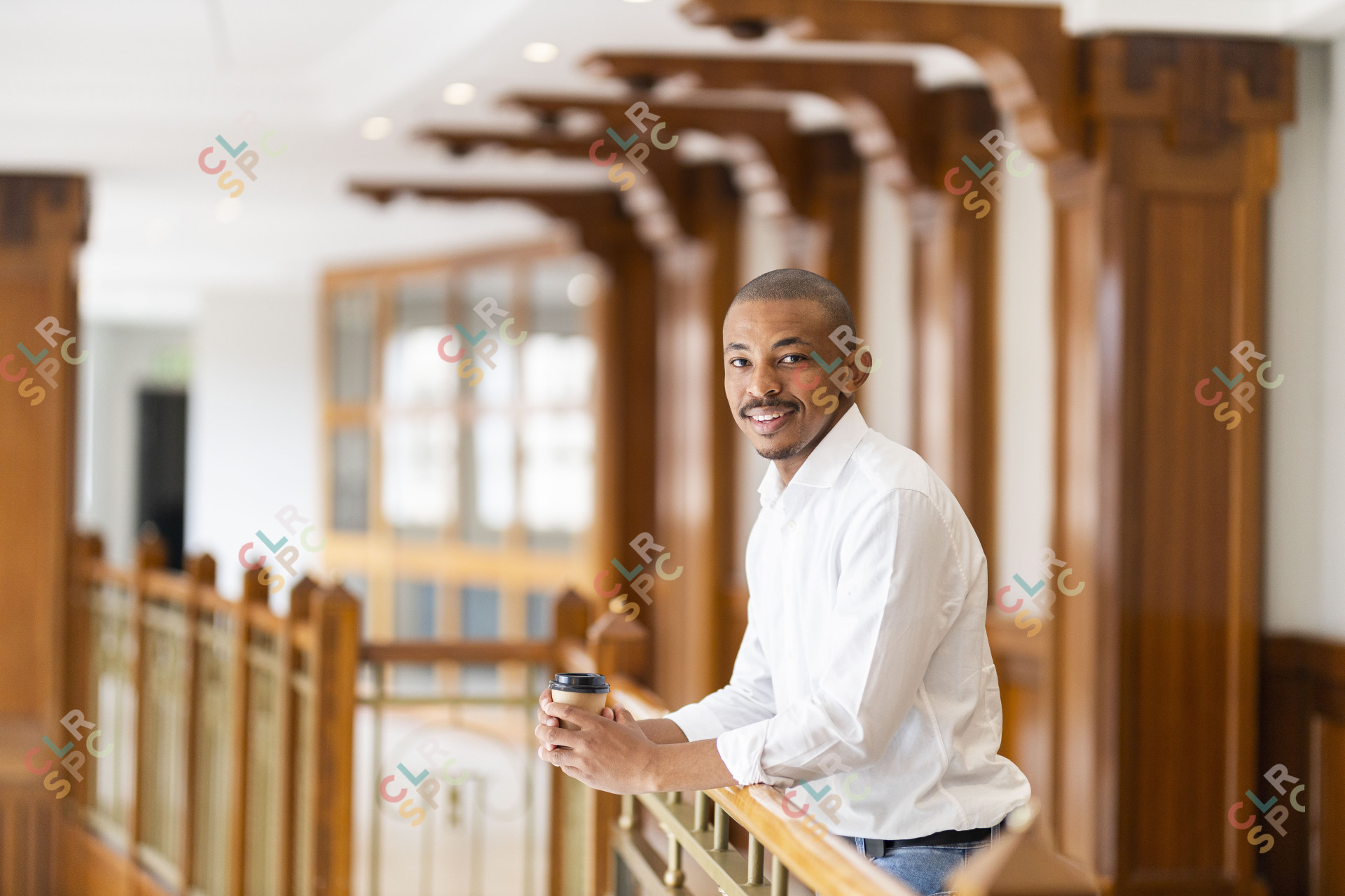 Black business man at work holding coffee