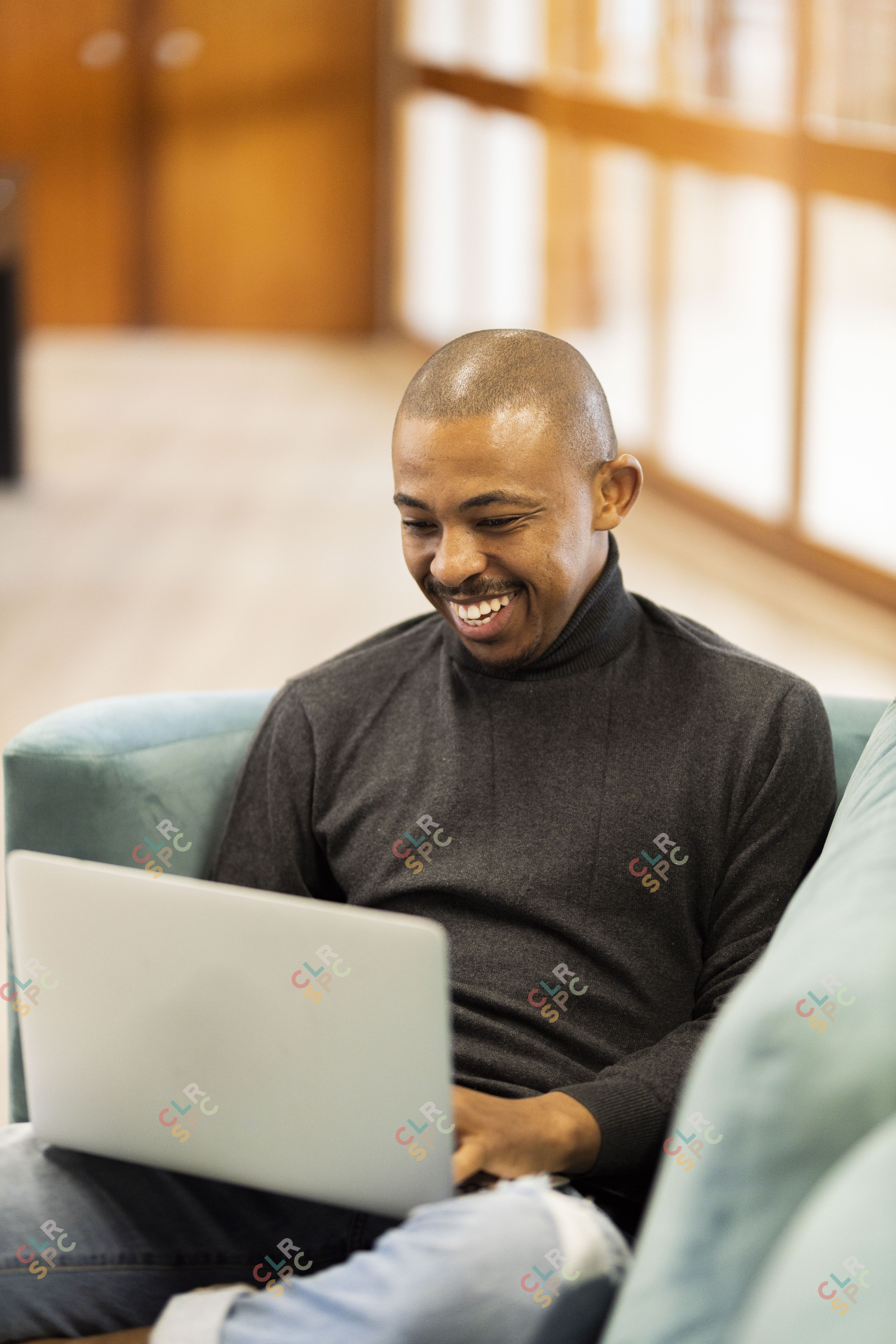 Black man working on his laptop at home