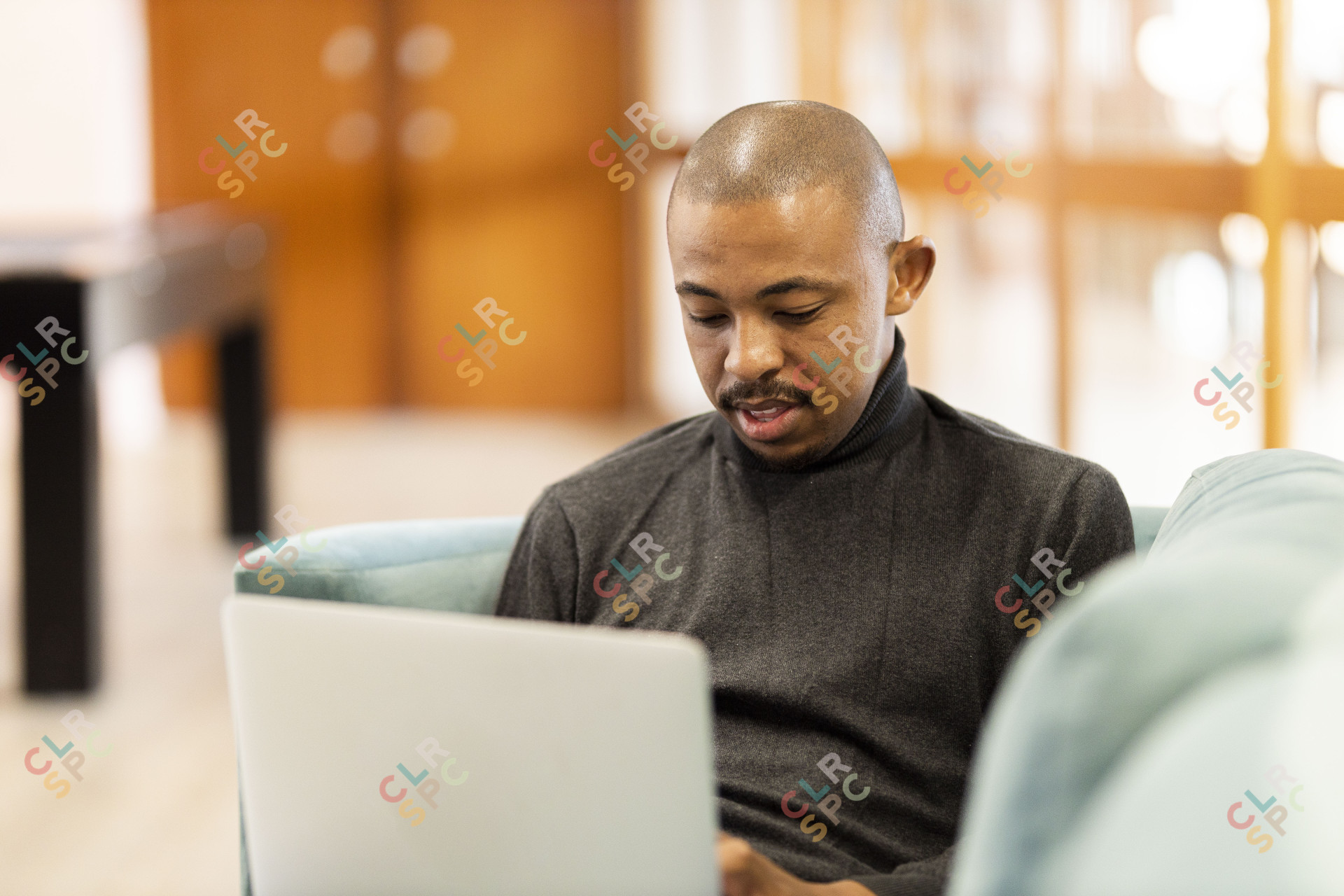 Black man working on his laptop at home