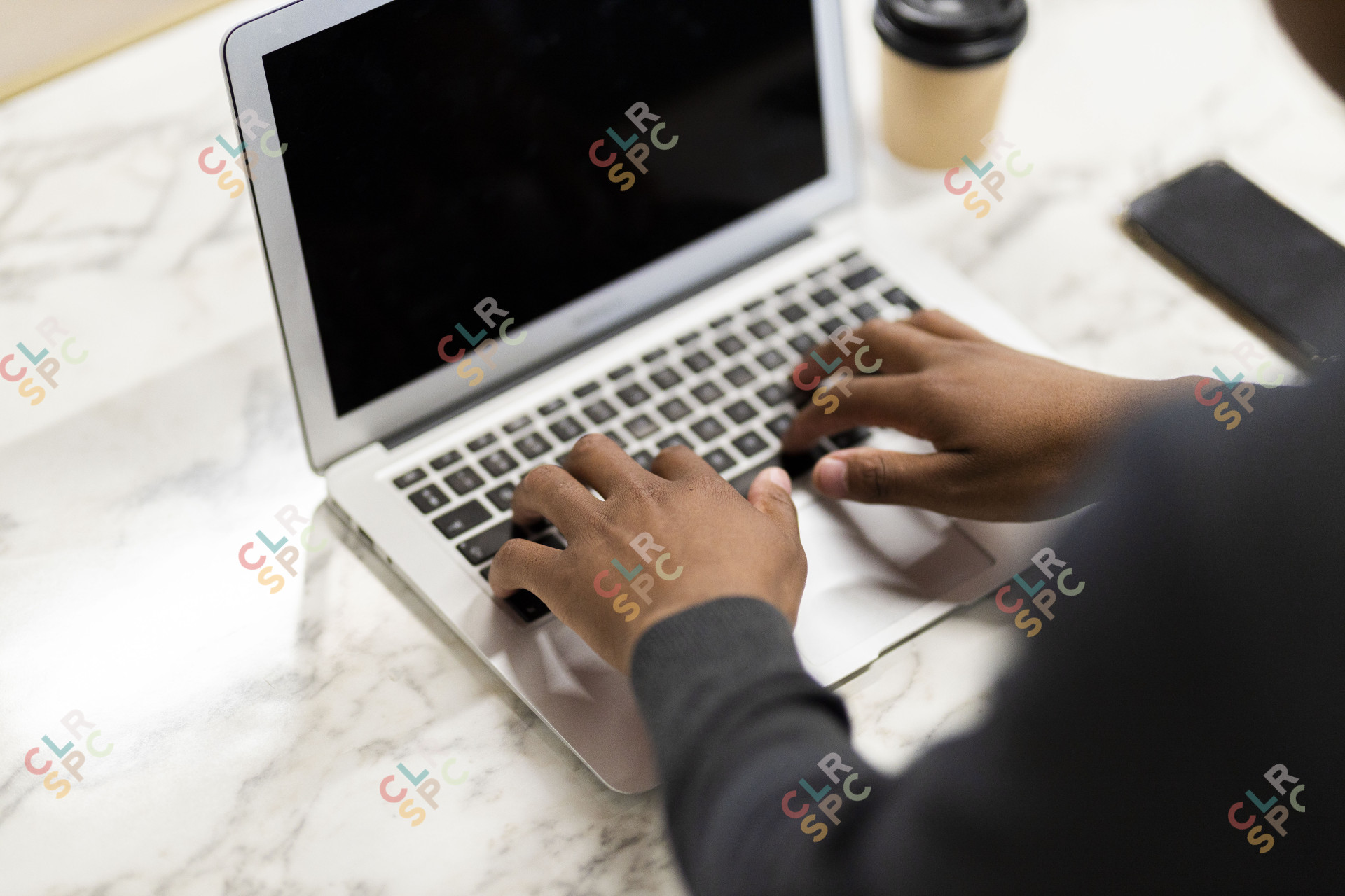 Black hands working on his laptop